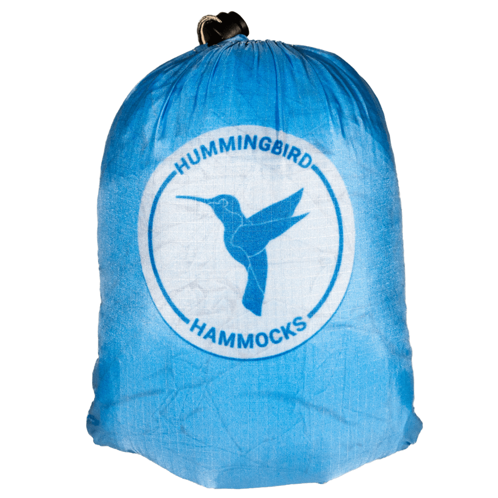 Blue Long Hammock stuff sack with "Hummingbird Hammocks" logo featuring a silhouette of a hummingbird, against a green background and includes the Button Link attachment system.