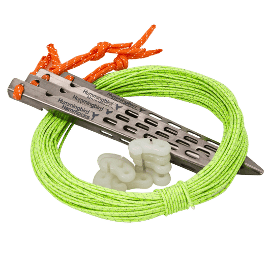 A bright green mountaineering rope coiled around a silver metal belay device with glow-in-the-dark friction adjusters, isolated on a green background, from the Guyline Kit by Hummingbird Hammocks.