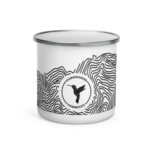 White Topo Enamel Camper Mug with a black and white logo featuring a hummingbird and the text "Hummingbird Hammocks" surrounded by wavy lines.