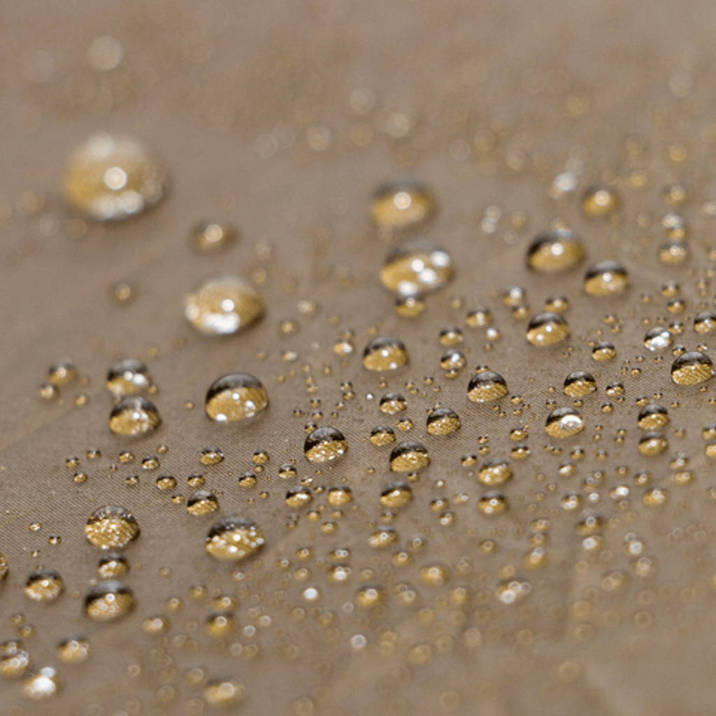 Close-up of water droplets on a Hummingbird Hammocks Pelican Rain Tarp surface, varying in size and shimmering subtly.