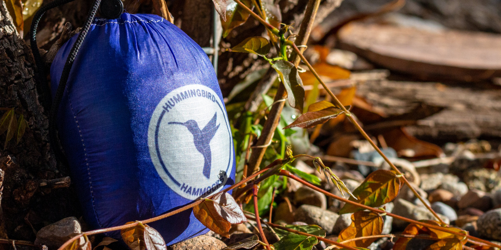 Deep Purple Single+ Hammock close up showing the dye sublimated logo in a natural setting