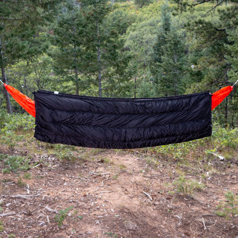Side view of the Puffin Underquilt hung on a hammock showing the symmetrical design